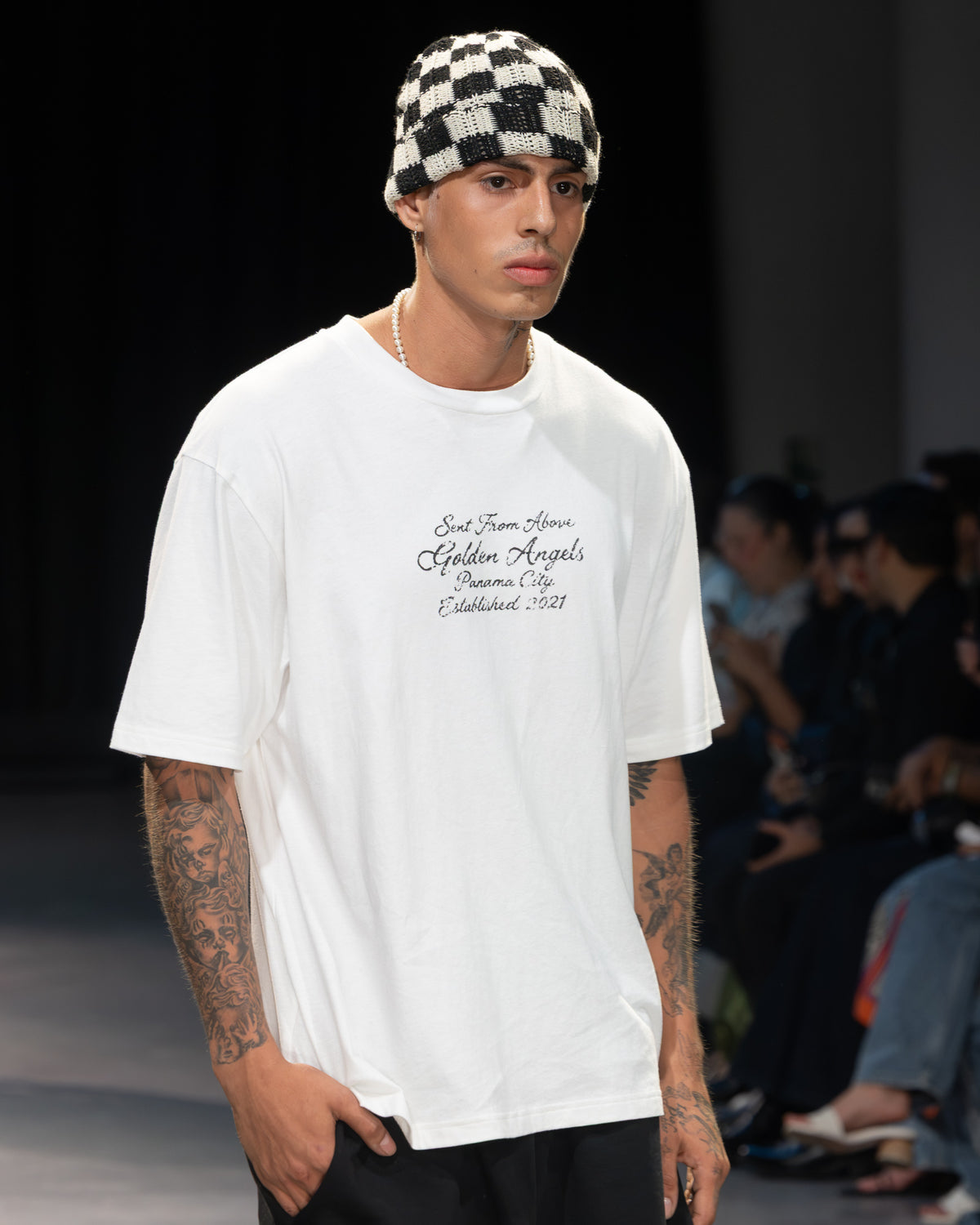 Golden Angels runway: White graphic T-shirt with a checkerboard knit cap
