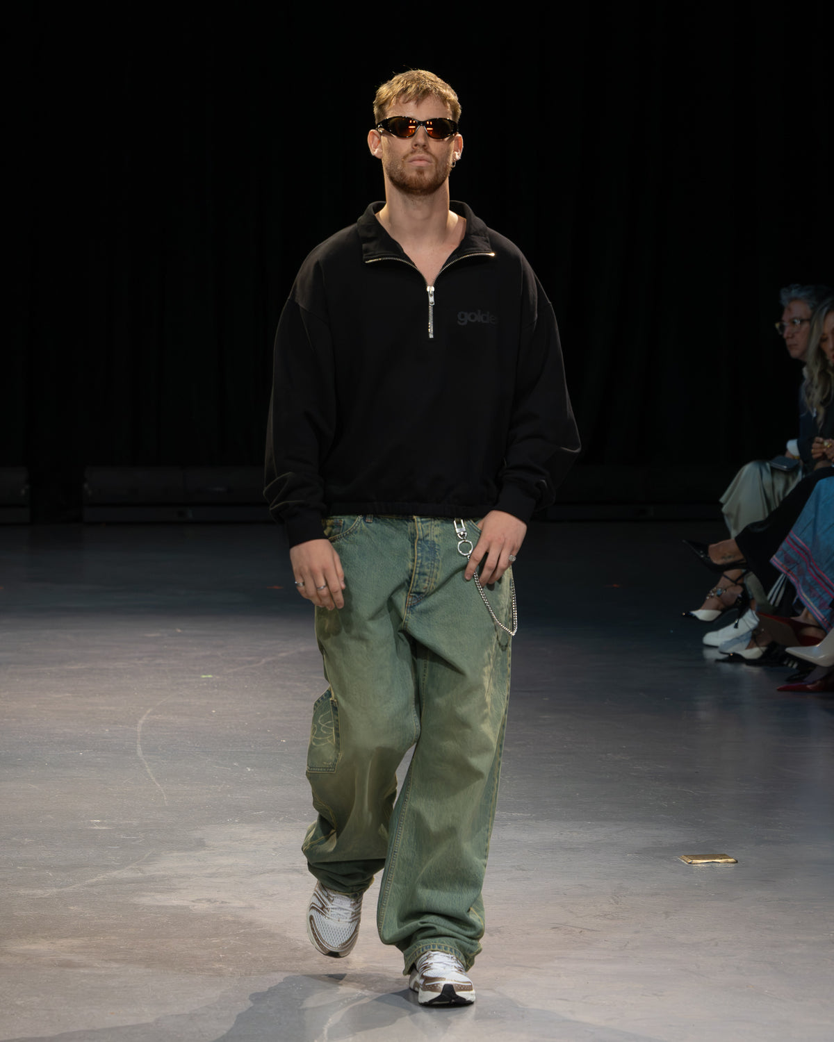 Golden Angels runway: Black zip-neck top with relaxed olive trousers